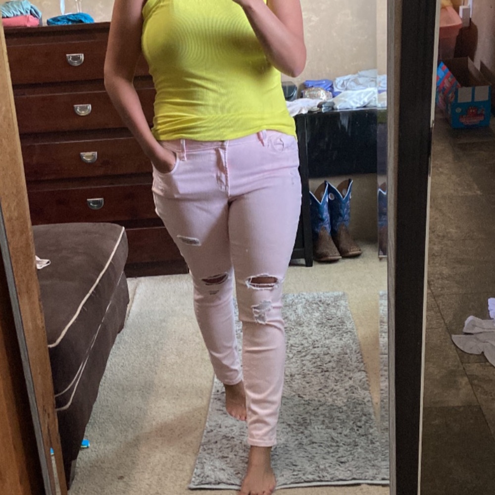Pale pink distressed skinny jeans